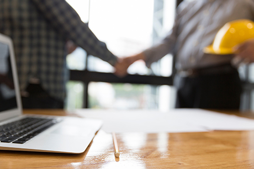 Florida Contractor Shaking Hands of Expert in LLC Setup Who Will Help Him Register New Corporation