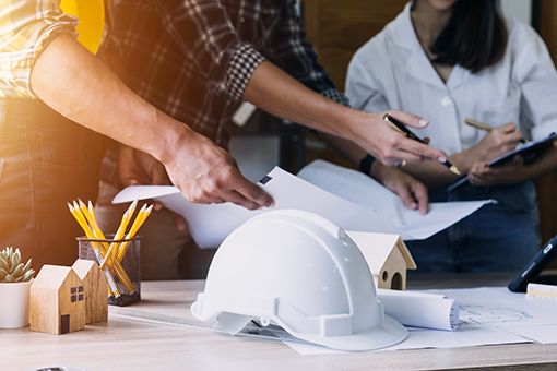 Two Engineers Showing Requirements to Florida Contractor Licensing Firm Who Will Process Their License Renewal