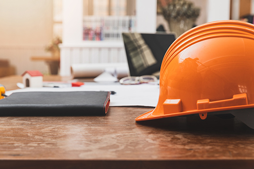Planner and Helmet of Engineer In Need of New Corporation and LLC Setup Assistance