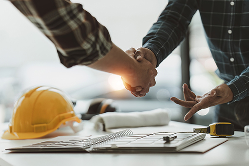Man Offering Licensing Services Shaking Hands of Florida Contractor