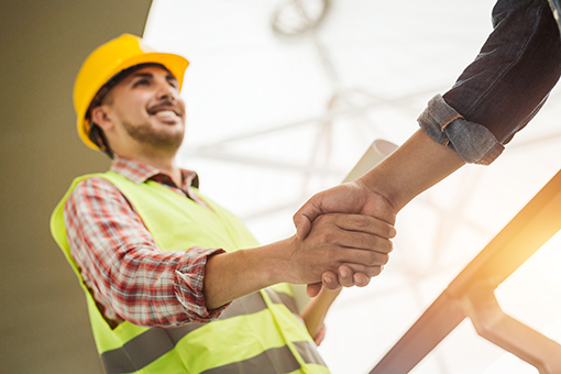 Florida Contractor Shaking Hands of Licensing Professional Who Helped Him Acquire General Contractors License