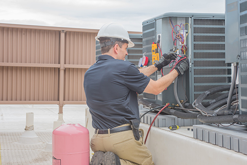 HVAC Contractor License Florida Contractor Repairing an Outdoor HVAC Unit in Florida Right After Getting His License