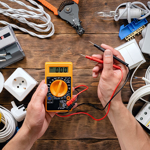 Electrician Using a Multimeter After Being Granted Florida Electical Contractor License and Other License Types